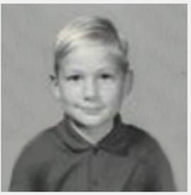 A young boy in a black and white photo.