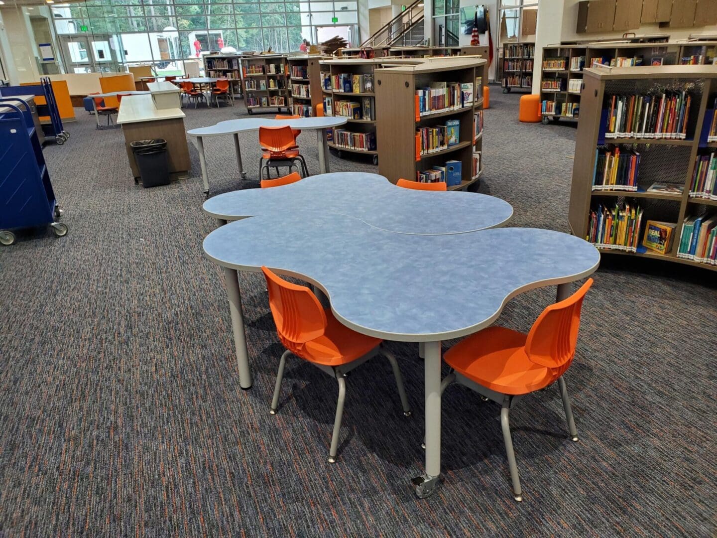 A library with tables and chairs in the shape of a cloud.