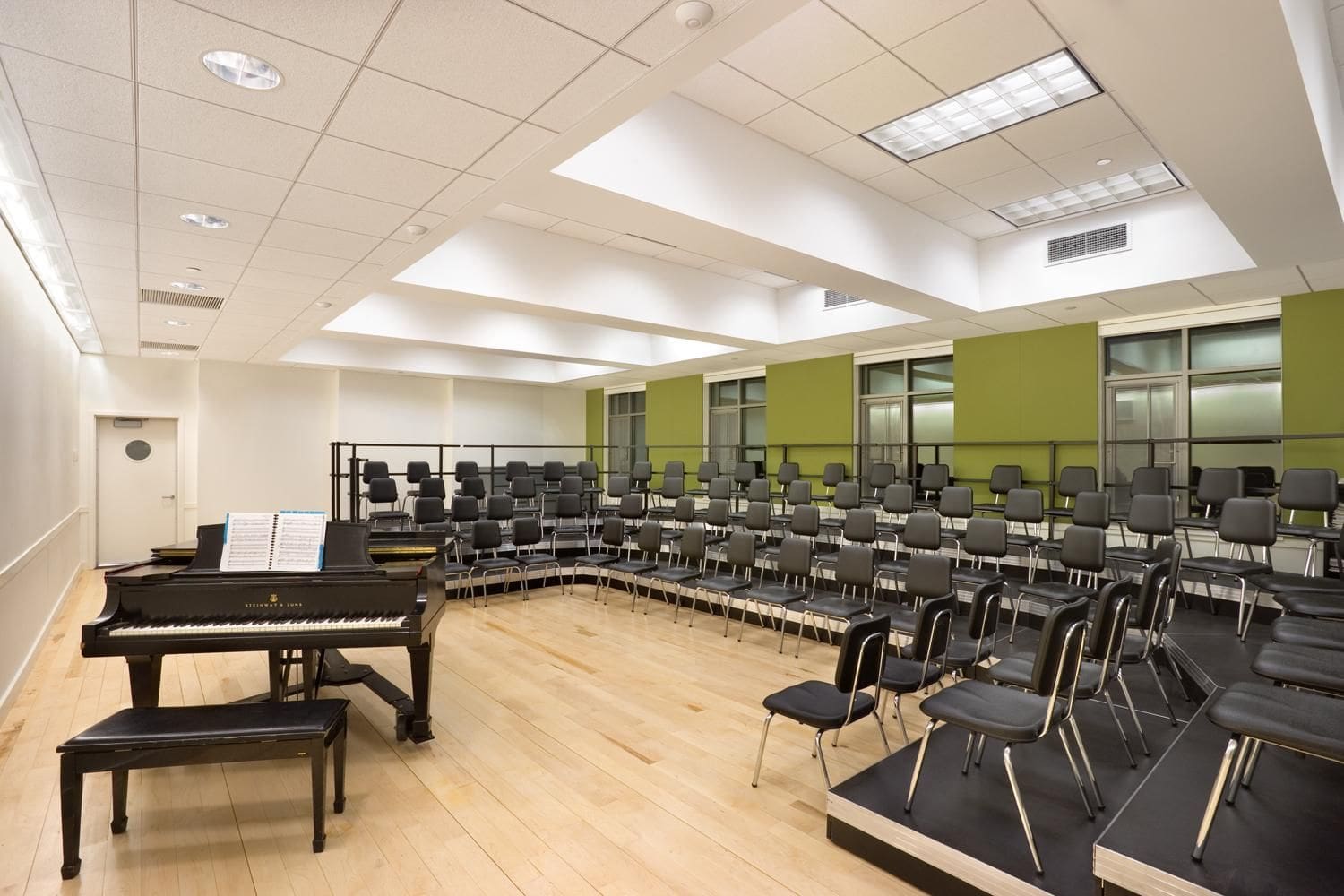 A large room with chairs and a piano