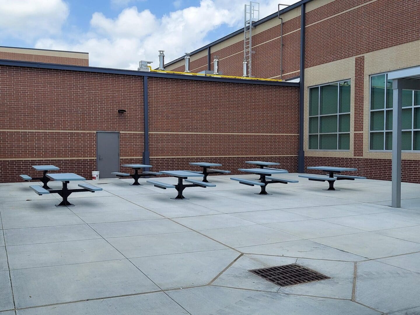 A group of tables sitting in the middle of an outdoor area.