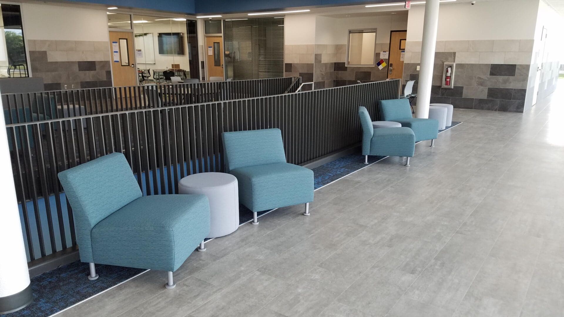 A row of blue chairs in an office building.