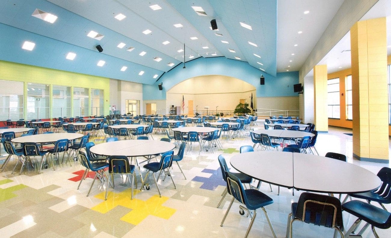 A large room with many tables and chairs.