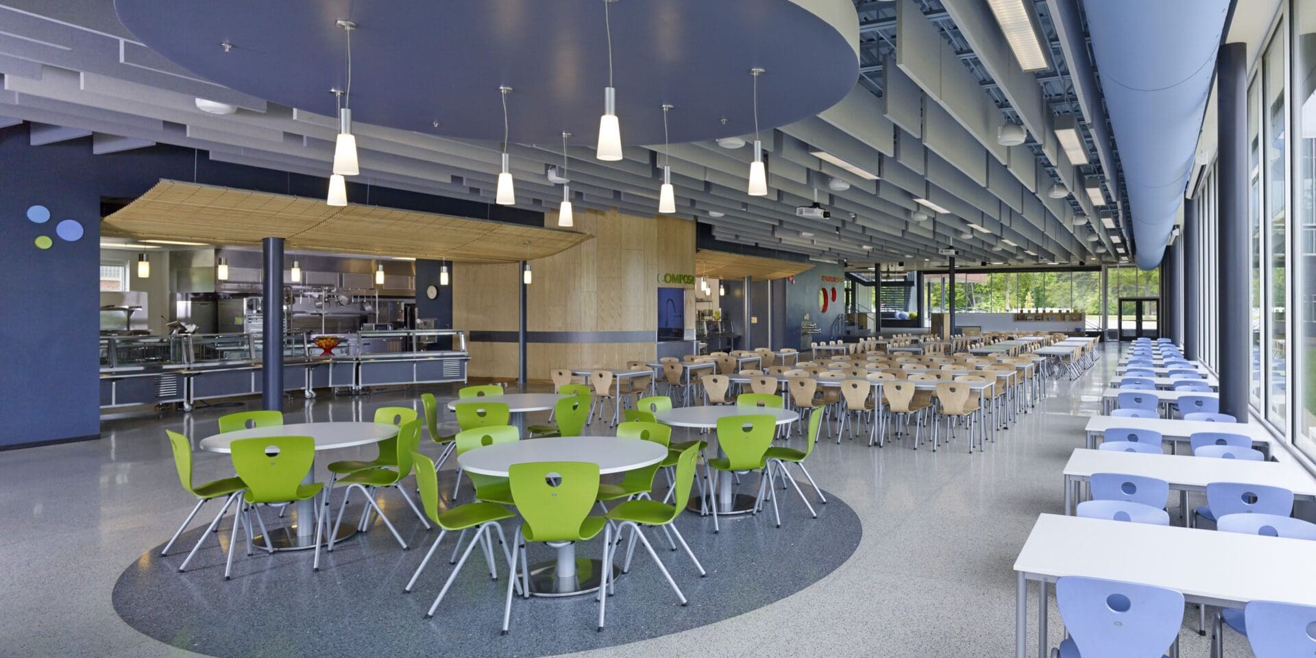 A cafeteria with many tables and chairs in it