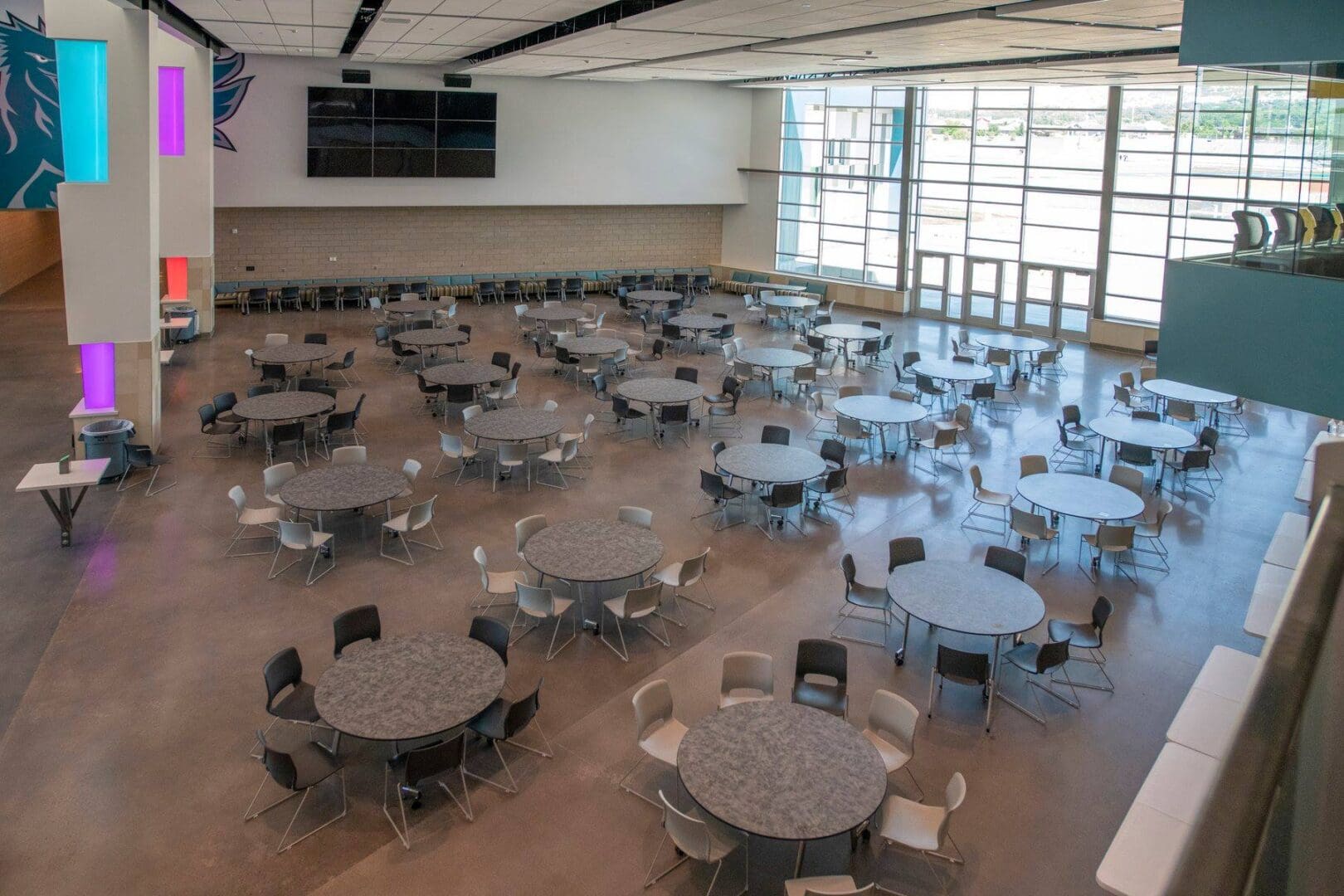 A large room with many tables and chairs.