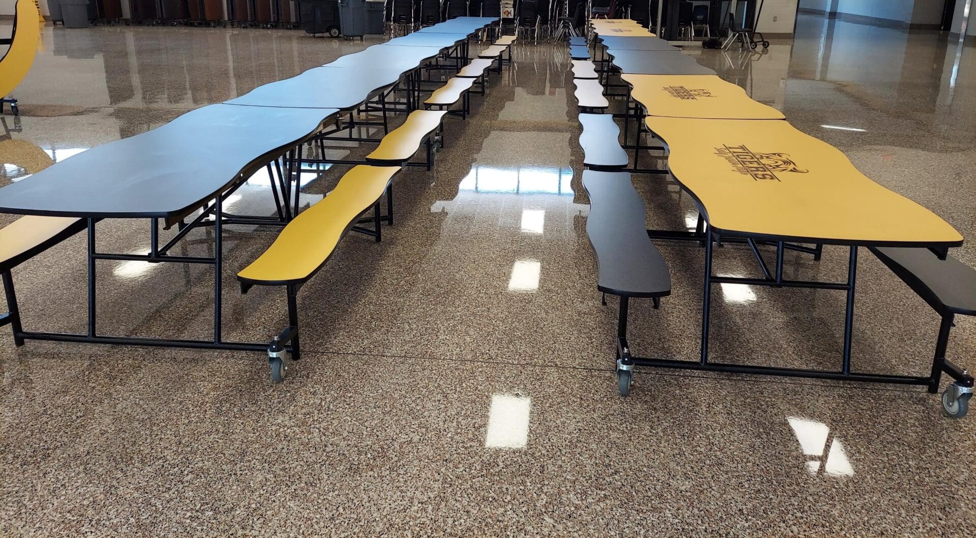 A group of tables with benches in the middle.