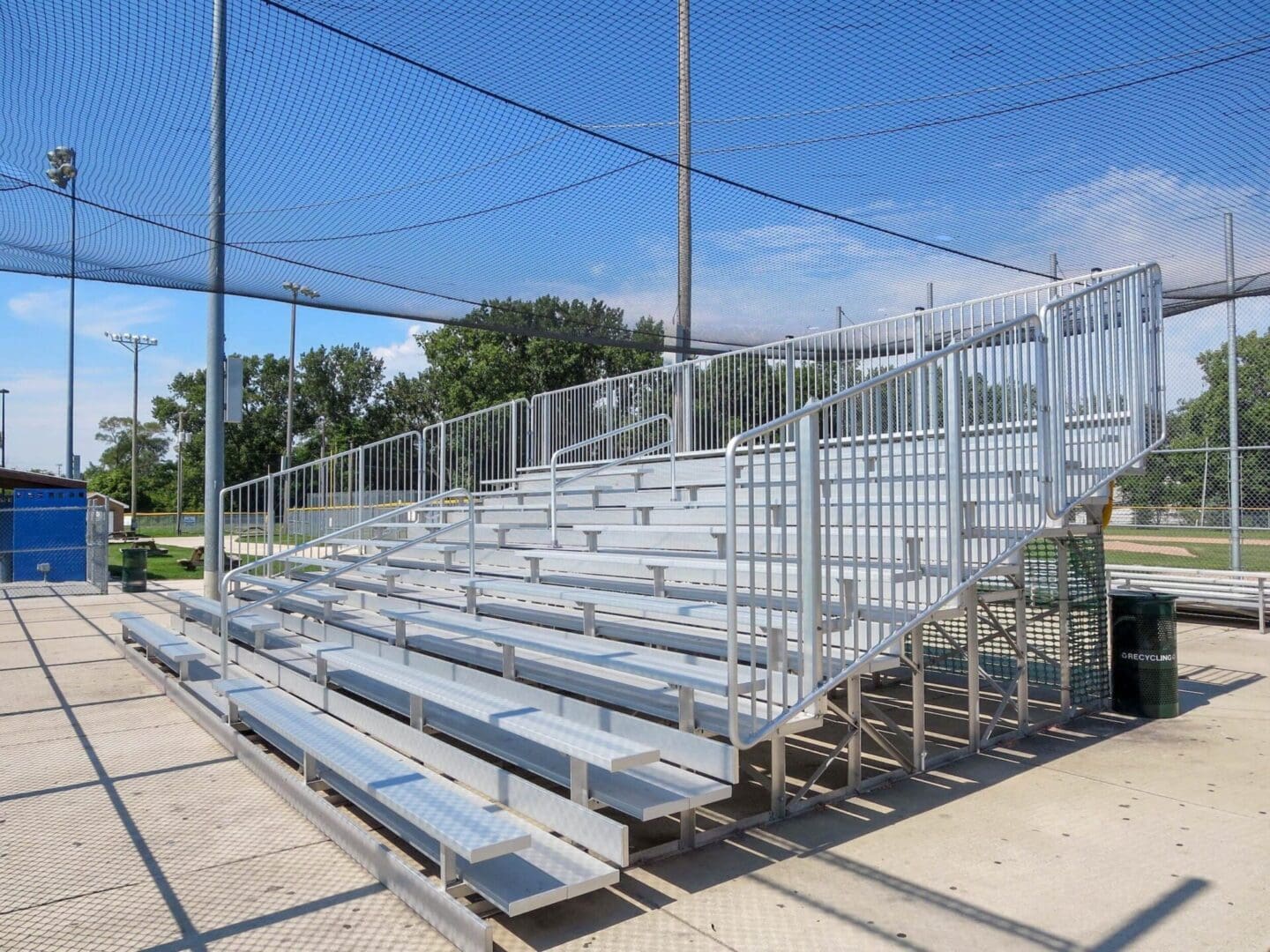 A bleacher with metal rails and seats.