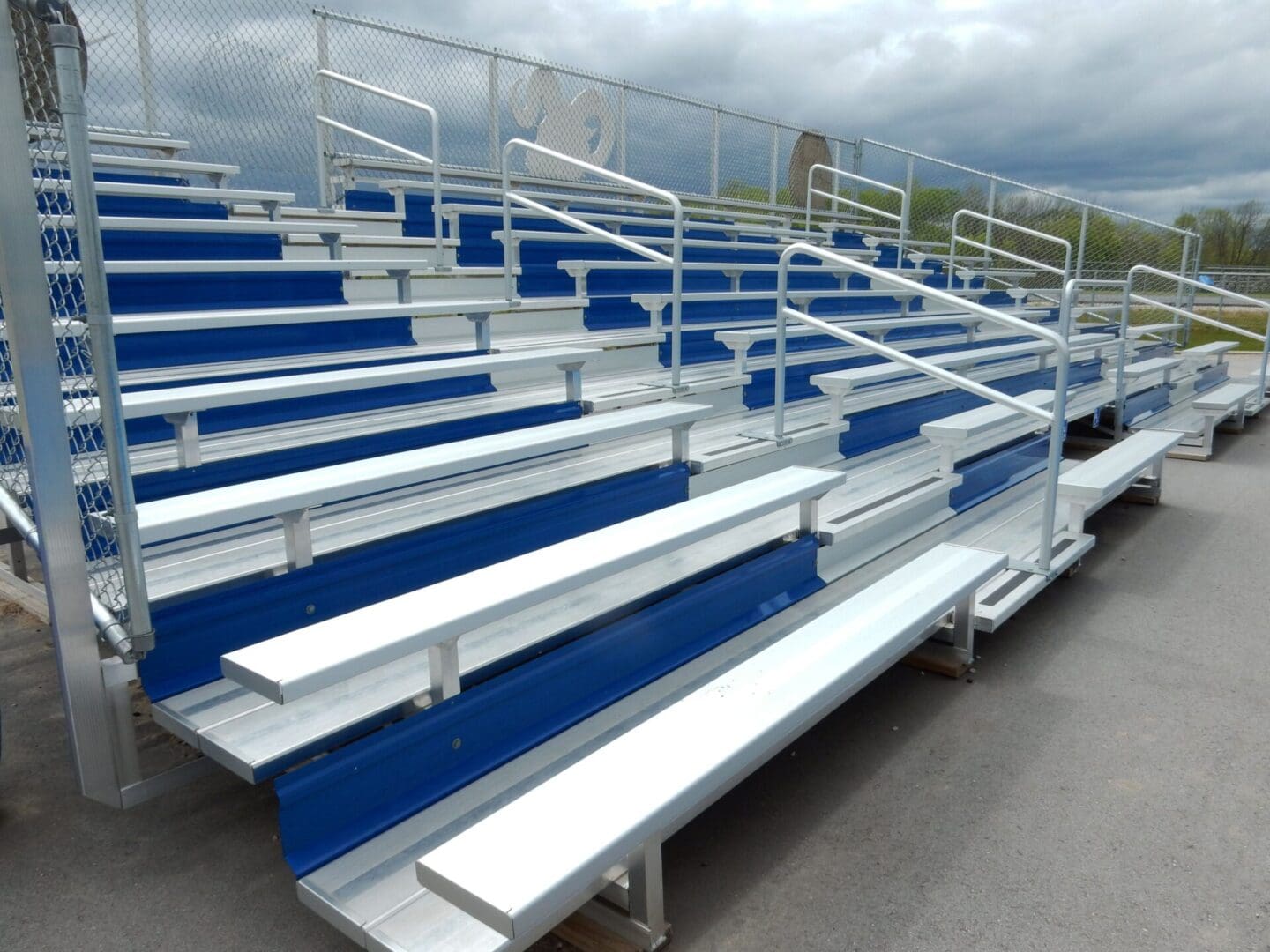 A group of bleachers with blue seats in the middle.