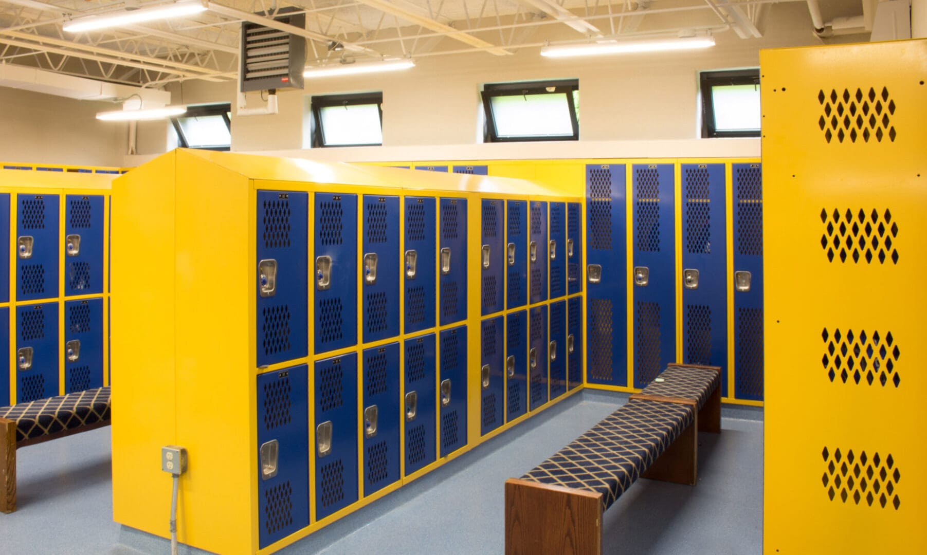 A room with many lockers and a bench