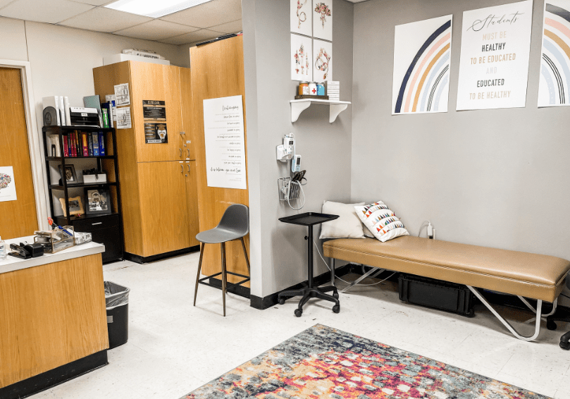 A room with a bed, chair and table.