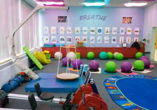 A room with several different colored balls and some toys.